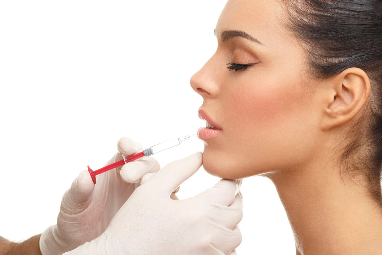 eautiful woman getting botox lip injection