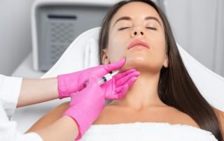 Cosmetologist Makes Lipolytic Injections to Burn Fat on the Chin, Cheeks and Neck of a Woman Against Double Chin.