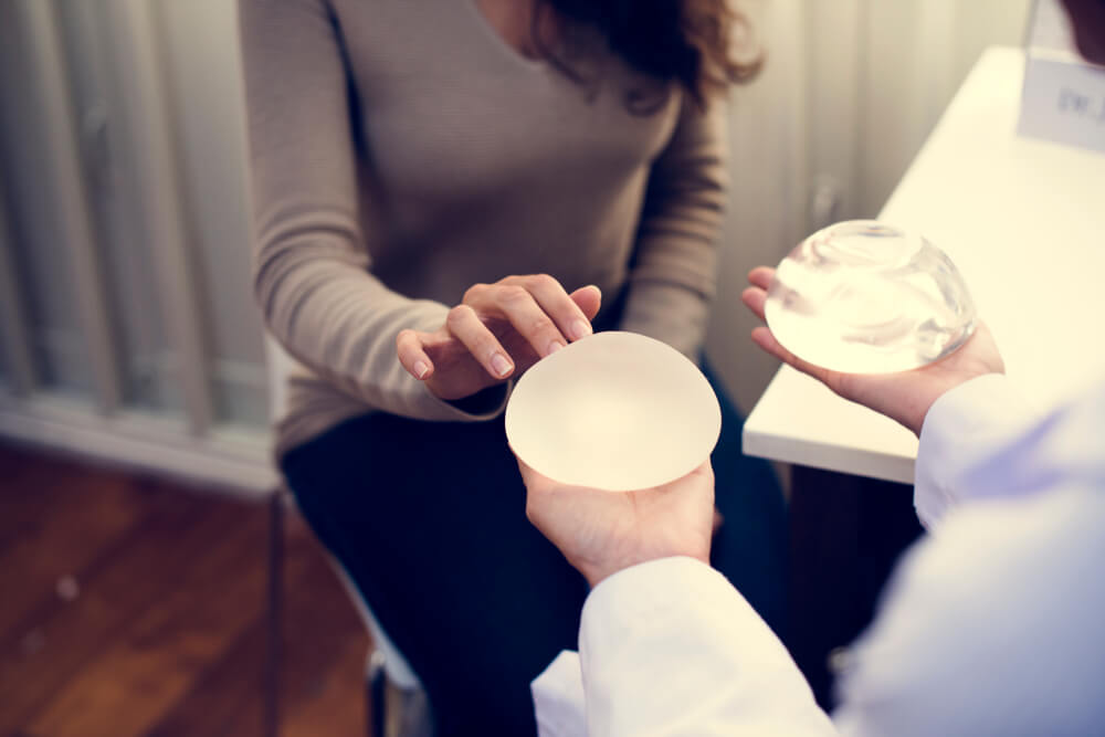 Woman Picking a Breast Implant