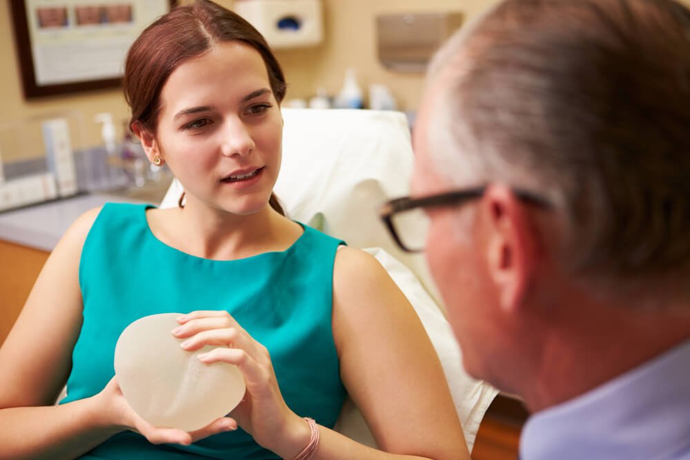 Woman Discussing Breast Augmentation With Plastic Surgeon